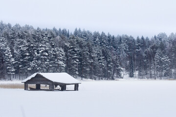 Old Wooden Boat Dock And Vintage Rowboat In Frozen Lake At Winter Lapland © Jorge
