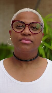 African American woman portrait with neutral serious expression outdoors, headshot