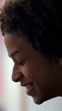 Happy Hispanic boy of African descent smiling against wall outdoors, feeling content