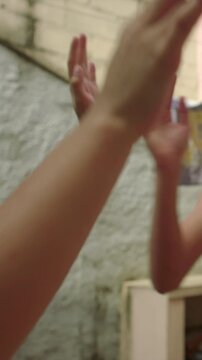 Joyful children clapping hands in courtyard, bright smiles and playful synergy