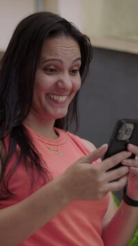 Joyful mature woman looking at smartphone outdoors, happy mobile interaction close up