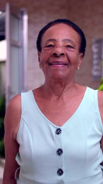 Smiling African American elderly woman portrait outdoors, cheerful expression