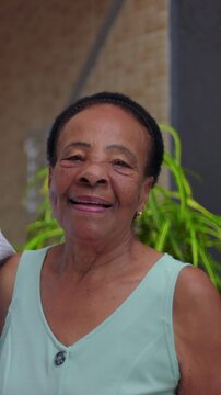 Smiling elderly African American woman headshot outdoors, joyful mature portrait