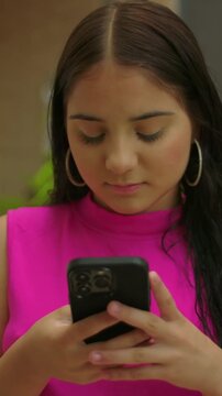 Young girl focused on smartphone outdoors, close up mobile interaction