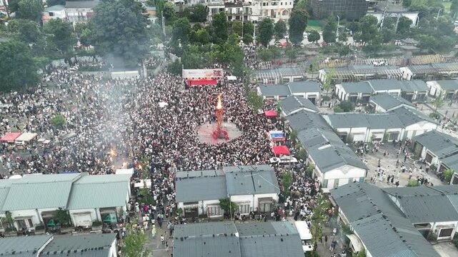 Aerial view of thousands of people celebrating the traditional Torch Festival in a village square, Southwest China, D-Log lossless file format