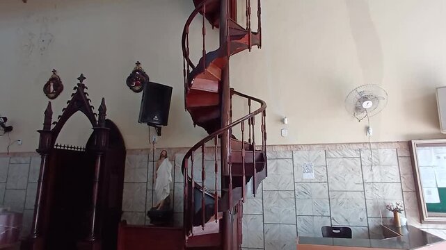 A confessional and an old wooden spiral staircase inside the Church of Nossa Senhora dos Rem&eacute;dios, located in the historic center of S&atilde;o Lu&iacute;s, Maranh&atilde;o, Brazil.
