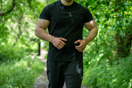 A man running along a forest path