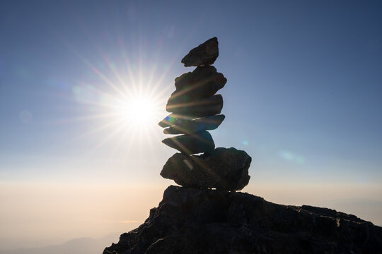 Balancing stones on the seashore at sunset