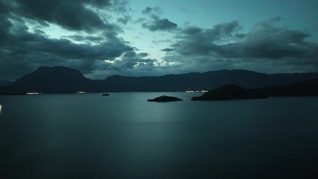 Aerial view of Lugu Lake islands at blue hour with dramatic clouds after sunset, Southwest China, D-Log lossless file format