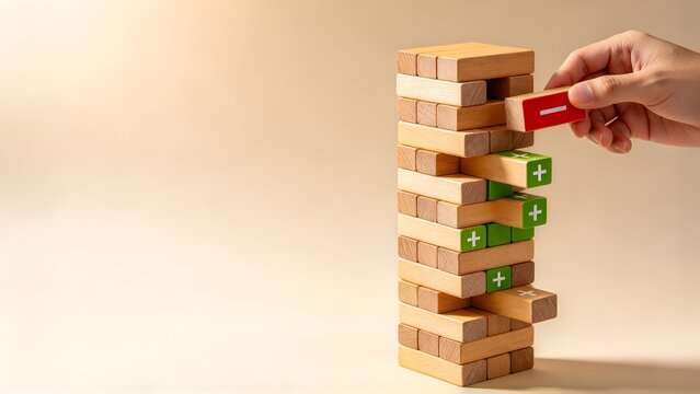 Hand Removing a Red Minus Symbol Wooden Block from a Tower of Green Plus Blocks, Concept of Optimization, Reducing Negativity, Improving Performance and Strategic Business Decision Making