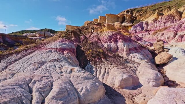 Colorful striped geological formations display vibrant clay layers in a close-up view at Paint Mines Interpretive Park