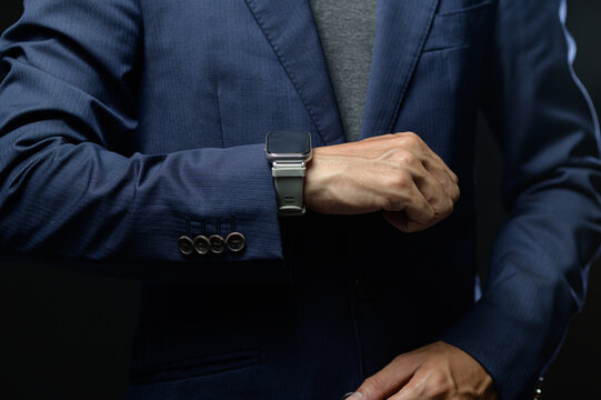 Close-up of Businessman Adjusting Cuff and Wearing Watch with Suit and Shirt