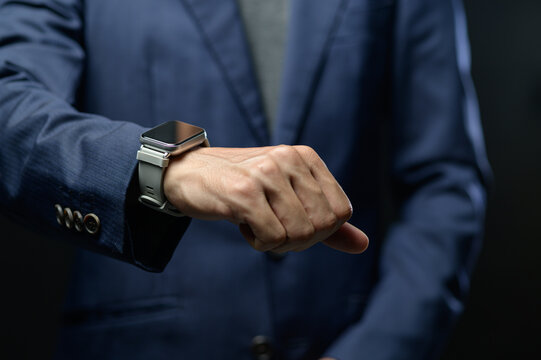 Businessman Checking Smart Watch on Wrist in Modern Office Setting