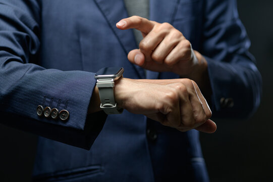 Business Professional Checking Smartwatch as It Displays Time and Notifications