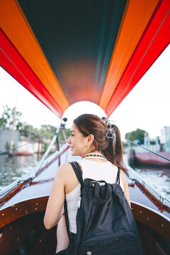Solo female traveler enjoy ride on long tail boat bangkok city river travel freedom journey