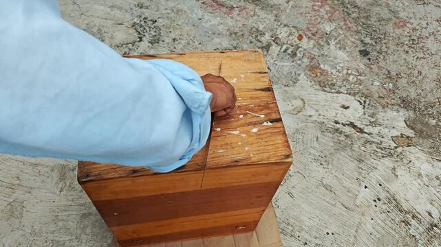 Hand Scraping Wooden Surface with Hacksaw Blade Before Painting