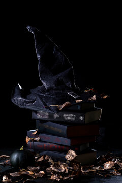 black witch hat on a stack of books