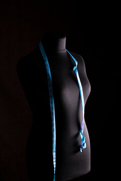 Silhouette of a female mannequin with a tailor's measuring tape