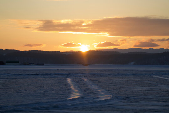 Sunlit wind ripple patterns across a wide snowfield, Hokkaido, Japan