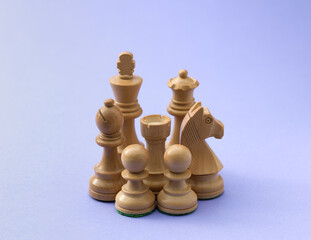 High Angle View of Wooden Chess Set on Purple Surface © stokkete