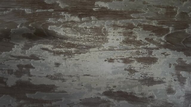 Static horizontal footage of a heavily distressed wooden surface with worn paint and exposed grain, ideal for grunge textures, rustic backgrounds, overlays, and vintage edits.