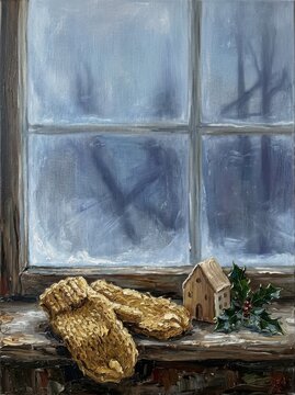 Handcrafted mittens and wooden house on windowsill with holly decoration