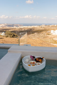Floating breakfast tray in a luxury infinity pool overlooking the