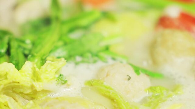 Close-up of Traditional Japanese Hot Pot with Chinese Cabbage, Leafy Greens and Seafood