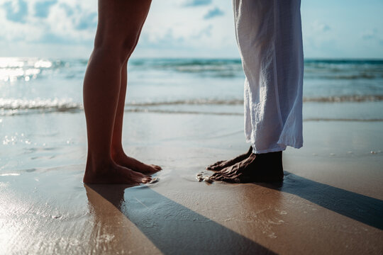 Eco-friendly travel concept with a young couple enjoying a barefoot moment on a pristine beach