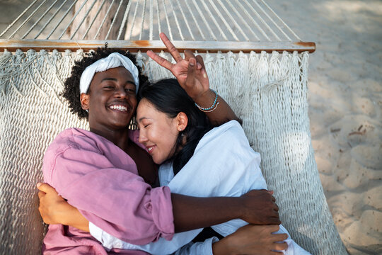 Happy interracial couple embracing and sharing a romantic moment during a tropical island getaway