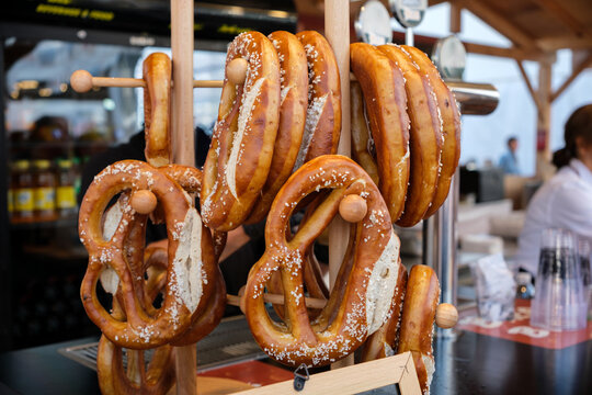 Pretzel display shows golden brown salted food at an outdoor market stall