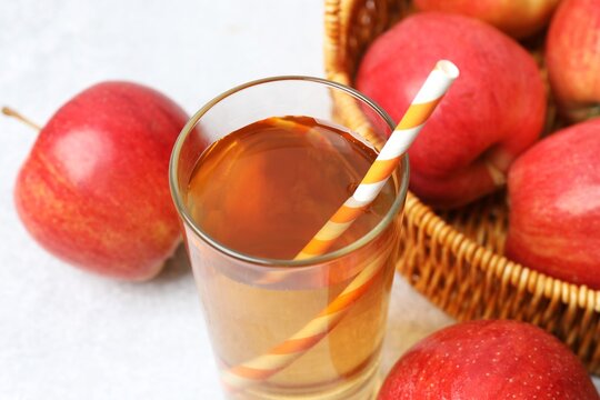 Glass of freshly squeezed apple juice on the table