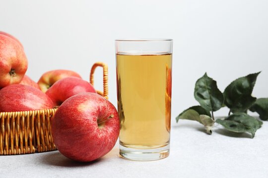 Glass of freshly squeezed apple juice on the table