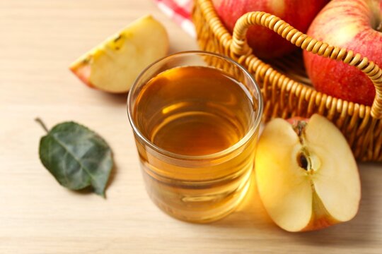Glass of freshly squeezed apple juice on the table