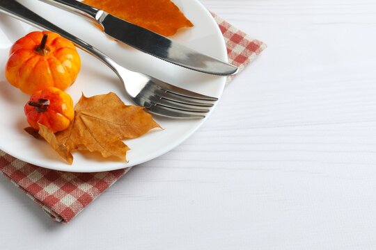 Rustic holiday table setup. Top view of plates, cutlery and autumn decorations. Thanksgiving day. Copy space