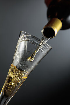 White sparkling wine is poured from a bottle into a glass.