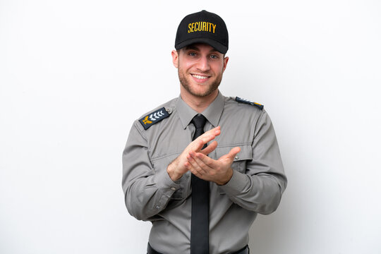 Young safeguard caucasian man isolated on white background applauding after presentation in a conference