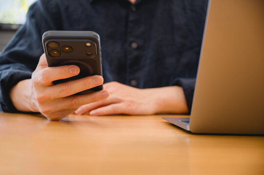 Social media marketing concept. Businessman hand using smartphone typing, chatting conversation in chat box icons pop up