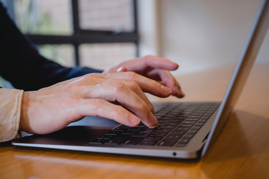 Business marketing Social media marketing concept. Businessman hand using computer laptop typing working in modern home office.