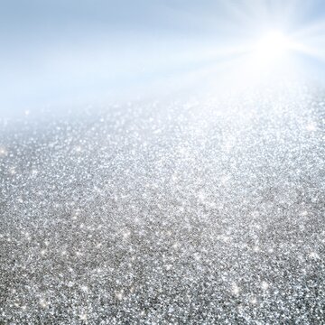 Sunlight shining on sparkling silver glitter surface