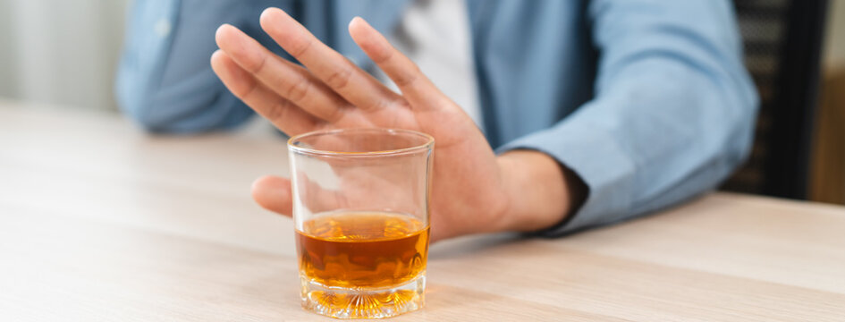 man refuse to drink alcohol say no to his friend.