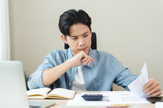Stressed bankrupt financial crisis concept, Young adult in nervous after calculated loan expense and can not pay to bank.