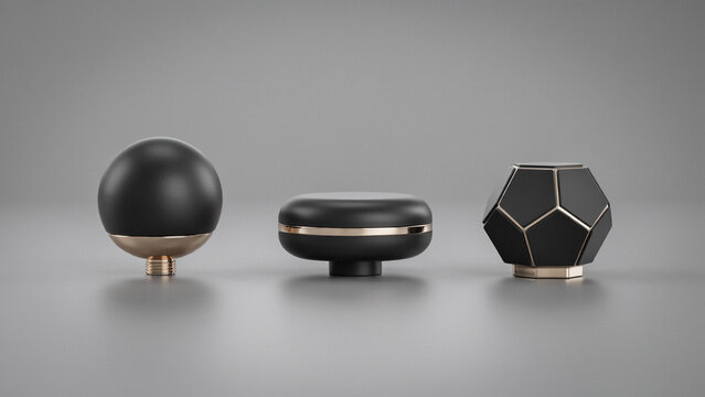 Three minimalist decorative knobs or furniture hardware pieces featuring matte black finishes and polished rose gold metallic accents on grey