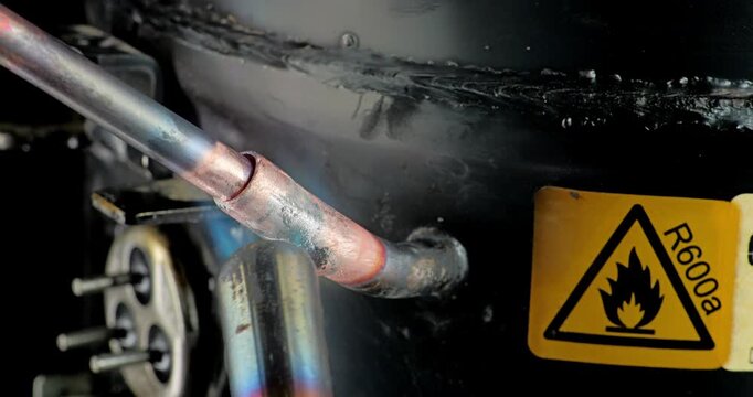 Copper Tube Brazing on Household Refrigerator Compressor. Copper tube is brazed onto household refrigerator compressor service port using torch heat. 