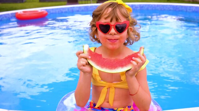 Children with watermelon near the pool. Selective focus. summer.