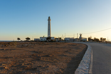 Breathtaking view of the emblematic Punta Sottile lighthouse during a dramatic warm sunset on the western tip of Favignana Island, Egadi Islands, Sicily, Italy.  Mediterranean sea by sunset © ANADEL
