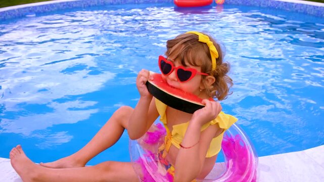 Children with watermelon near the pool. Selective focus. summer.