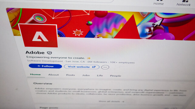 Adobe company profile page featuring iconic red logo with bold white typeface on vibrant abstract banner with colorful spheres for creative software brand identity.