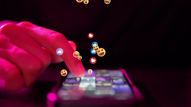 Online popularity, hand tapping smartphone with emoji and heart reactions floating in pink neon light