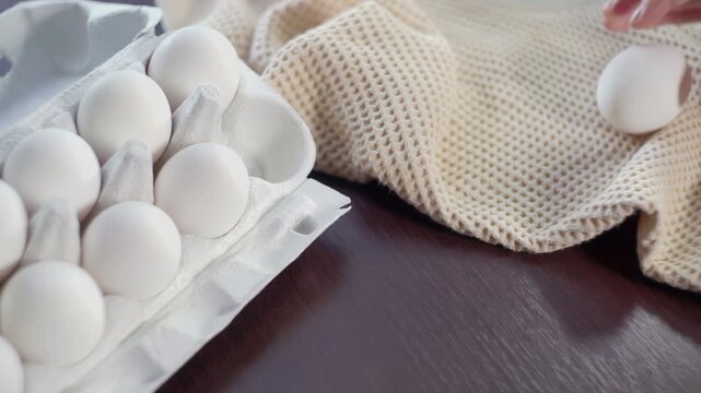 Woman hands taking chicken eggs carton. Close up cooking ingredients kitchen.